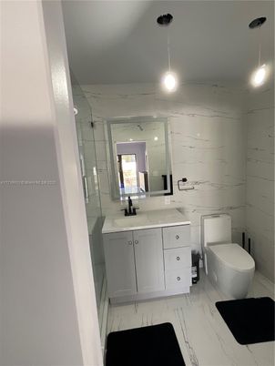 Bathroom, Dual Sink Vanities, Glass Shower, Interior, Marble, Marble Walls, Pendant Lights