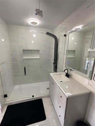 Bathroom, Dual Sink Vanities, Glass Shower, Interior, Marble, Marble Walls, Recessed Lighting
