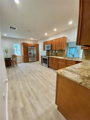 Dining room, Interior, Kitchen, Recessed Lighting, Stainless Steel Appliances, Wood Texture Flooring