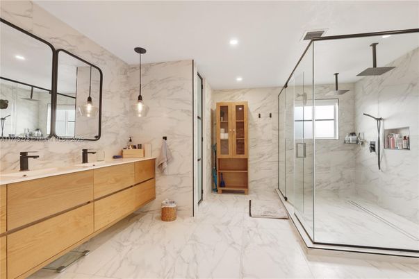 Bathroom, Dual Sink Vanities, Glass Shower, Interior, Marble, Marble Walls, Pendant Lights, Recessed Lighting