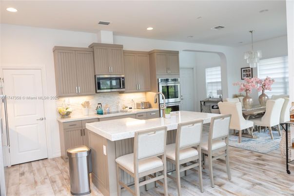 Chandelier, Dining room, Interior, Kitchen, Pendant Lights, Recessed Lighting, Stainless Steel Appliances, Wood Texture Flooring