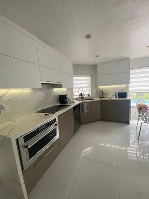 Interior, Kitchen, Marble Walls, Recessed Lighting, Stainless Steel Appliances