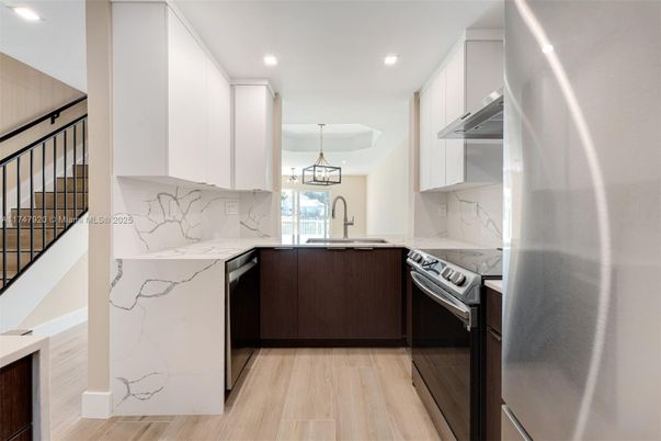Interior, Kitchen, Marble Walls, Pendant Lights, Recessed Lighting, Stainless Steel Appliances, Wood Texture Flooring