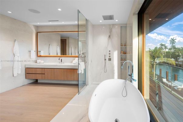 Bathroom, Dual Sink Vanities, Free Standing Baths, Interior, Marble Walls, Recessed Lighting, Wood Texture Flooring