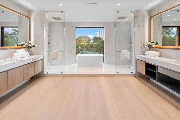 Bathroom, Free Standing Baths, Glass Shower, Interior, Marble Walls, Recessed Lighting, Wood Texture Flooring