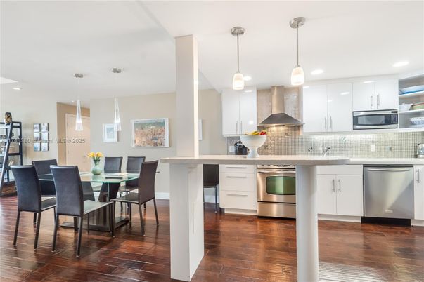 Dining room, Interior, Kitchen, Pendant Lights, Recessed Lighting, Stainless Steel Appliances, Wood Texture Flooring