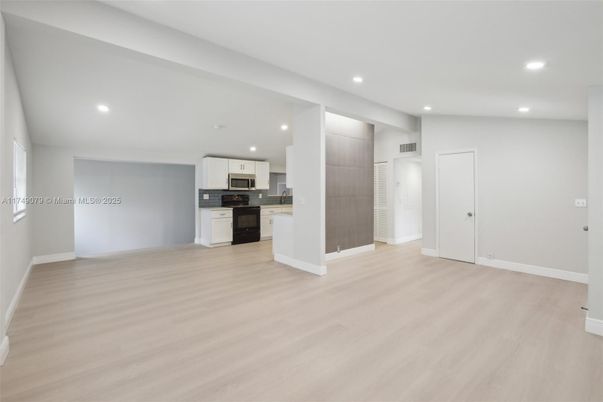 Empty room, Interior, Kitchen, Recessed Lighting, Stainless Steel Appliances, Wood Texture Flooring
