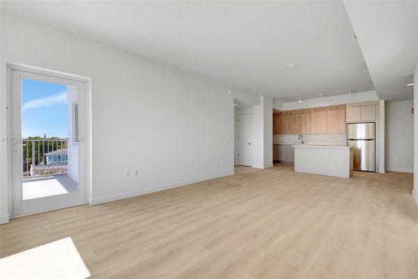 Empty room, Interior, Kitchen, Recessed Lighting, Stainless Steel Appliances, Wood Texture Flooring
