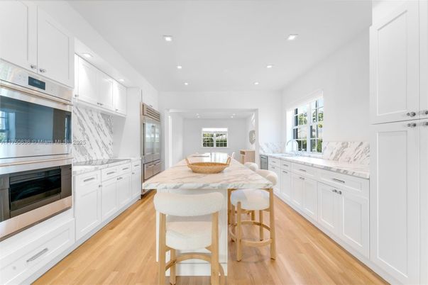 Interior, Kitchen, Marble Walls, Recessed Lighting, Stainless Steel Appliances, Wood Texture Flooring