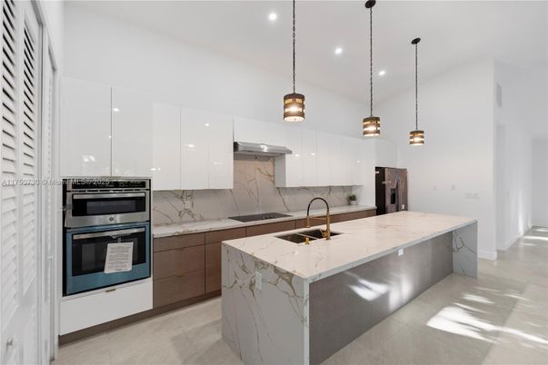 Interior, Kitchen, Marble Walls, Pendant Lights, Recessed Lighting, Stainless Steel Appliances