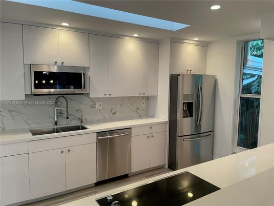 Interior, Kitchen, Marble Walls, Recessed Lighting, Stainless Steel Appliances