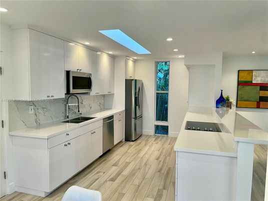 Interior, Kitchen, Marble Walls, Recessed Lighting, Stainless Steel Appliances, Wood Texture Flooring