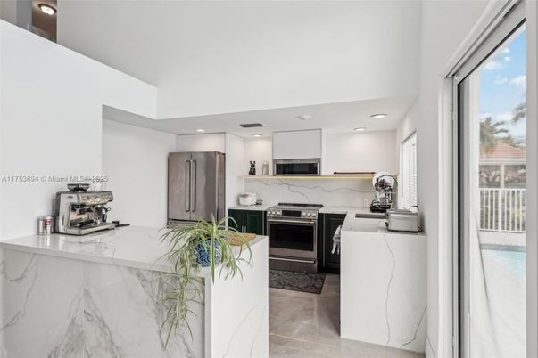 Interior, Kitchen, Marble Walls, Recessed Lighting, Stainless Steel Appliances