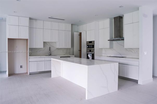Interior, Kitchen, Marble Walls, Recessed Lighting, Stainless Steel Appliances, Wood Texture Flooring
