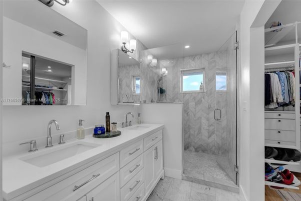 Bathroom, Dual Sink Vanities, Glass Shower, Interior, Marble, Marble Walls, Recessed Lighting, Walk-in Closets