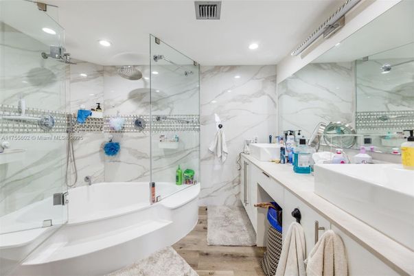 Bathroom, Dual Sink Vanities, Free Standing Baths, Glass Shower, Interior, Marble Walls, Recessed Lighting, Wood Texture Flooring