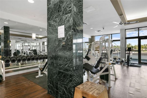 Fitness Equipment, Gym, Interior, Marble Walls, Recessed Lighting, Wood Texture Flooring