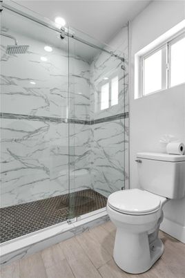 Bathroom, Glass Shower, Interior, Marble Walls, Wood Texture Flooring