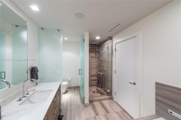 Bathroom, Dual Sink Vanities, Glass Shower, Interior, Recessed Lighting, Wood Texture Flooring
