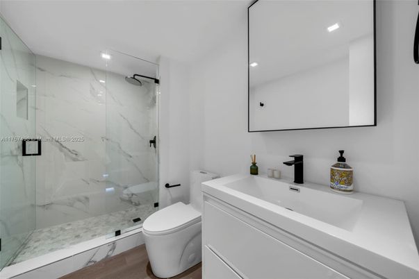 Bathroom, Glass Shower, Interior, Marble Walls, Recessed Lighting, Wood Texture Flooring