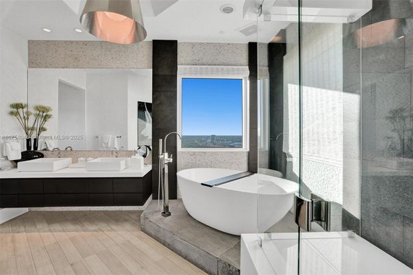 Bathroom, Dual Sink Vanities, Free Standing Baths, Glass Shower, Interior, Recessed Lighting, Wood Texture Flooring