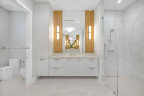 Bathroom, Dual Sink Vanities, Glass Shower, Interior, Marble Walls, Recessed Lighting