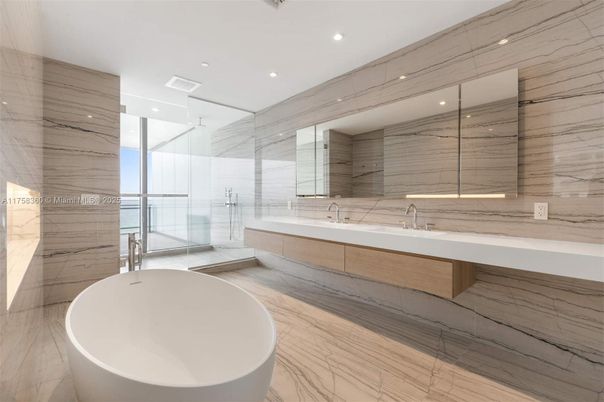 Bathroom, Dual Sink Vanities, Free Standing Baths, Glass Shower, Interior, Marble, Marble Walls, Recessed Lighting, Wood Texture Flooring