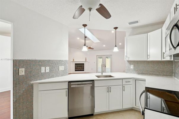 Fireplace, Interior, Kitchen, Pendant Lights, Recessed Lighting, Stainless Steel Appliances, Wood Texture Flooring