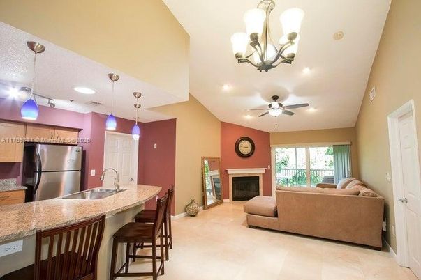 Chandelier, Fireplace, Interior, Kitchen, Living room, Pendant Lights, Recessed Lighting, Stainless Steel Appliances