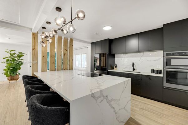 Interior, Kitchen, Marble Walls, Pendant Lights, Recessed Lighting, Stainless Steel Appliances, Wood Texture Flooring