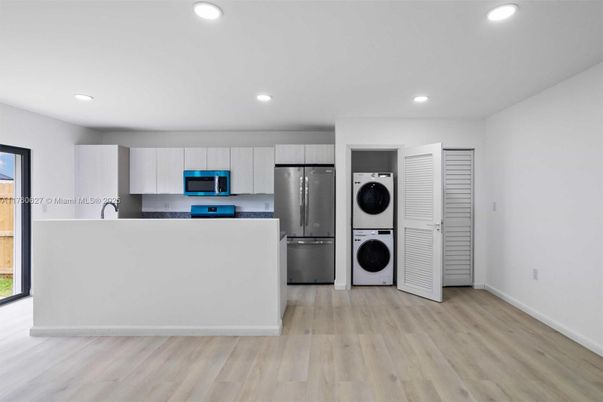 Interior, Kitchen, Recessed Lighting, Stainless Steel Appliances, Washer, Wood Texture Flooring