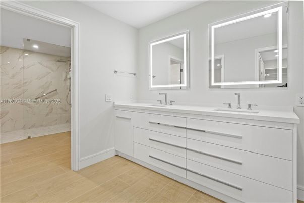 Bathroom, Dual Sink Vanities, Glass Shower, Interior, Marble Walls, Recessed Lighting, Wood Texture Flooring