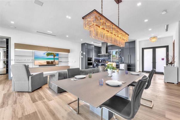 Chandelier, Dining room, Fireplace, Interior, Kitchen, Living room, Recessed Lighting, Stainless Steel Appliances, Wood Texture Flooring