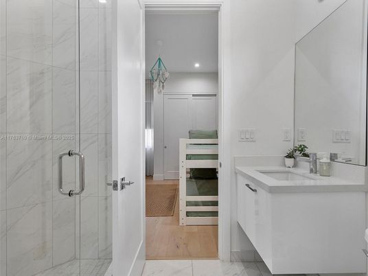 Bathroom, Dual Sink Vanities, Glass Shower, Interior, Marble, Marble Walls, Recessed Lighting, Wood Texture Flooring