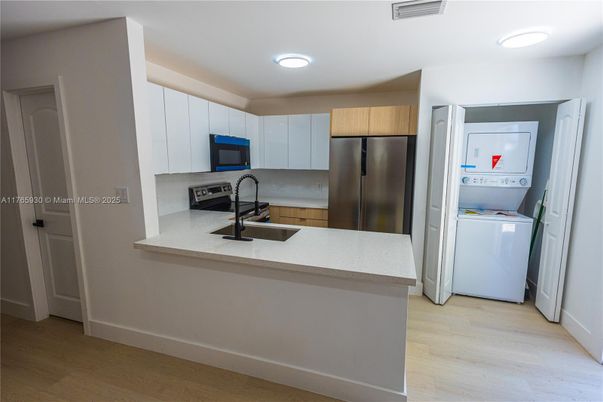 Interior, Kitchen, Recessed Lighting, Washer, Wood Texture Flooring