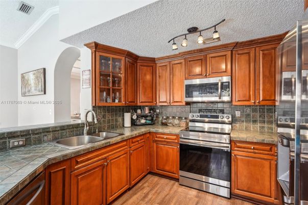 Interior, Kitchen, Stainless Steel Appliances, Tile Countertops, Wood Texture Flooring