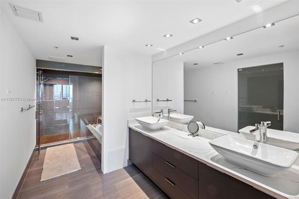 Bathroom, Dual Sink Vanities, Glass Shower, Interior, Recessed Lighting, Wood Texture Flooring