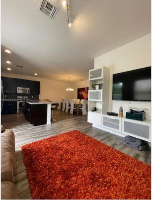 Chandelier, Dining room, Interior, Kitchen, Pendant Lights, Recessed Lighting, Stainless Steel Appliances, Wood Texture Flooring