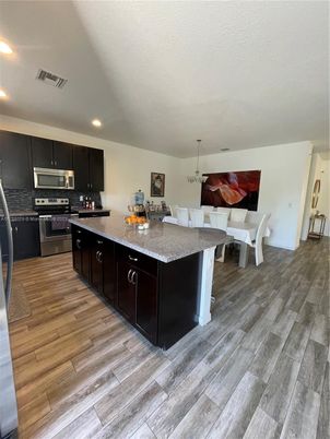 Dining room, Interior, Kitchen, Recessed Lighting, Stainless Steel Appliances, Wood Texture Flooring