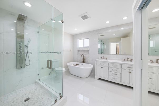 Bathroom, Dual Sink Vanities, Free Standing Baths, Glass Shower, Interior, Marble Walls, Recessed Lighting
