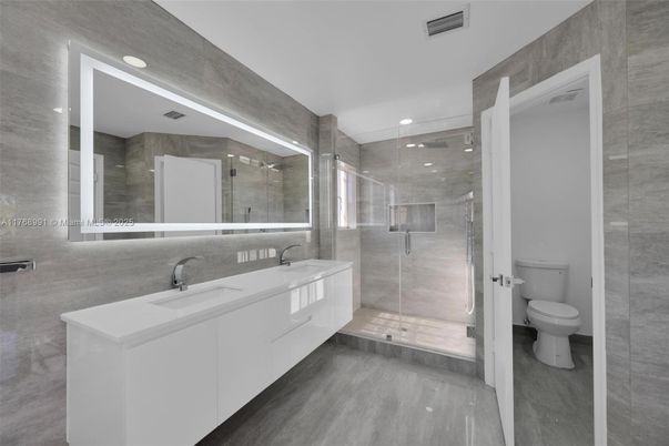 Bathroom, Dual Sink Vanities, Glass Shower, Interior, Recessed Lighting, Wood Texture Flooring