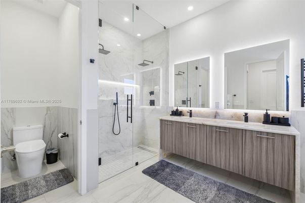 Bathroom, Dual Sink Vanities, Glass Shower, Interior, Marble, Marble Walls, Recessed Lighting