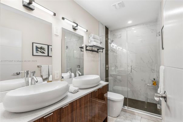 Bathroom, Dual Sink Vanities, Glass Shower, Interior, Marble Walls, Recessed Lighting