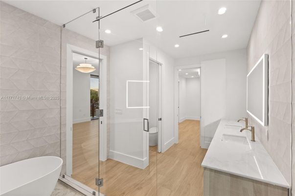 Bathroom, Free Standing Baths, Glass Shower, Interior, Pendant Lights, Recessed Lighting, Wood Texture Flooring