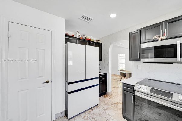 Interior, Kitchen, Marble Walls, Recessed Lighting, Stainless Steel Appliances