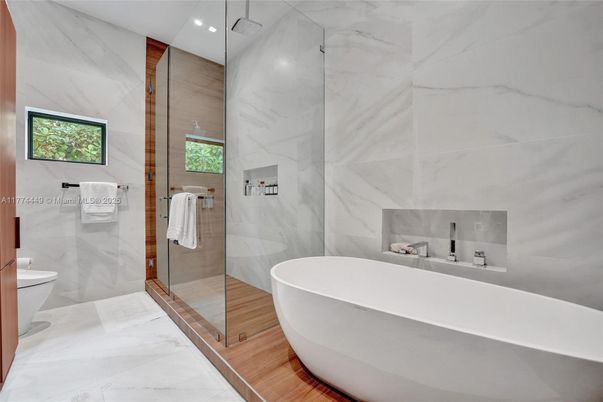 Bathroom, Free Standing Baths, Glass Shower, Interior, Marble, Marble Walls, Recessed Lighting, Wood Texture Flooring