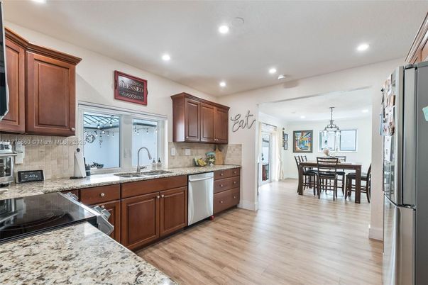Dining room, Interior, Kitchen, Pendant Lights, Recessed Lighting, Stainless Steel Appliances, Wood Texture Flooring