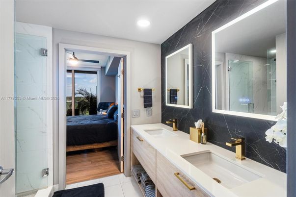 Bathroom, Bedroom, Dual Sink Vanities, Glass Shower, Interior, Marble Walls, Recessed Lighting, Wood Texture Flooring