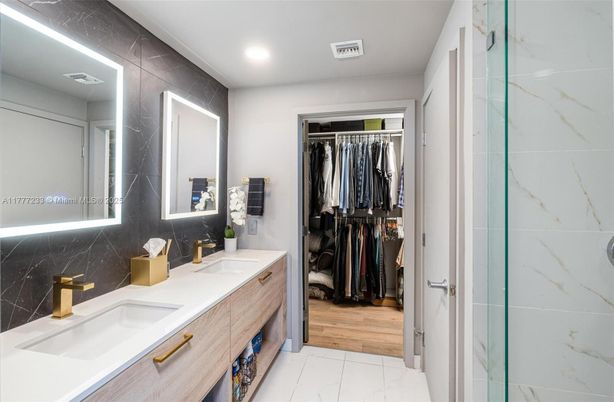 Bathroom, Dual Sink Vanities, Interior, Marble, Marble Walls, Recessed Lighting, Walk-in Closets, Wood Texture Flooring