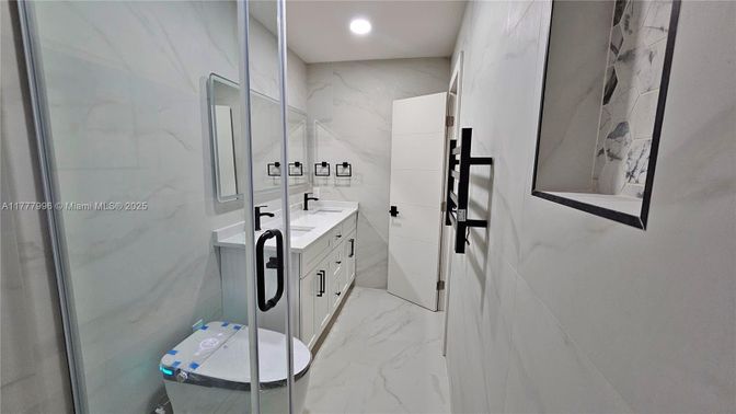 Bathroom, Dual Sink Vanities, Glass Shower, Interior, Marble, Marble Walls, Recessed Lighting